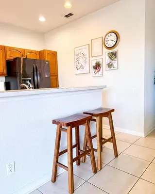 a kitchen with two stools in front of a counter at WH7783TB-Windsor Hills- 10 guests - in Orlando