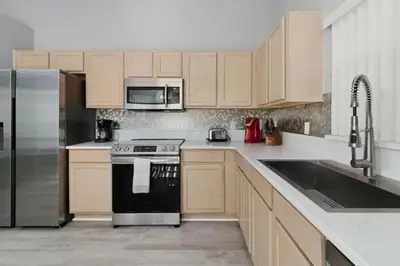 a kitchen with a stove and a refrigerator at IC8090ICB - Indian Creek Oasis in Kissimmee