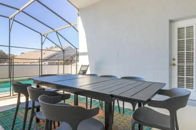 a table and chairs in a room with a large window at IC8090ICB - Indian Creek Oasis in Kissimmee