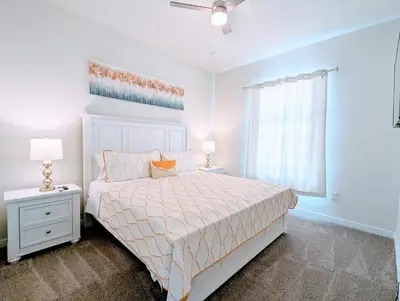 a white bedroom with a bed and a window at Brand New 3 Suites 5 min to Disney in Orlando