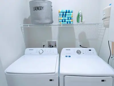a laundry room with a washer and dryer at Brand New 3 Suites 5 min to Disney in Orlando