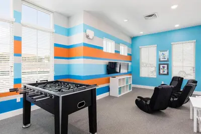a blue and orange room with a ping pong table at Brand New 3 Suites 5 min to Disney in Orlando