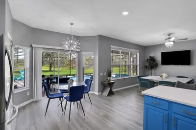 a kitchen and dining room with a table and chairs at Themed Luxury 6BR Getaway with Resort Amenities in Orlando