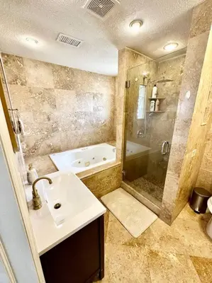 a bathroom with a sink and a shower and a tub at Superhost FREE Heated Pool 9 minutes to MCO 15 minutes to Disney in Kissimmee