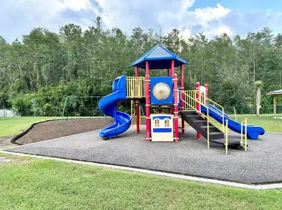 a playground with a slide in a park at Superhost FREE Heated Pool 9 minutes to MCO 15 minutes to Disney in Kissimmee