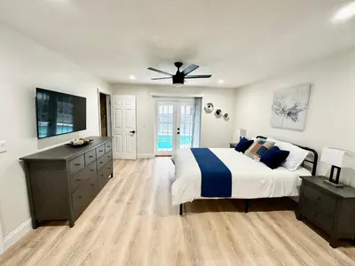 a bedroom with a bed and a ceiling fan at Superhost FREE Heated Pool 9 minutes to MCO 15 minutes to Disney in Kissimmee