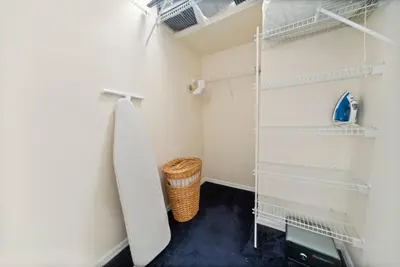 a walk in closet with white walls and shelves at Lakeview Family Haven in Kissimmee - Pool & Scenic Views in Kissimmee