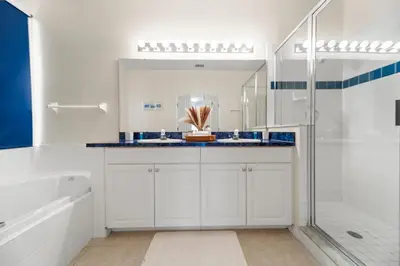 a white bathroom with a tub and a shower at Lakeview Family Haven in Kissimmee - Pool & Scenic Views in Kissimmee