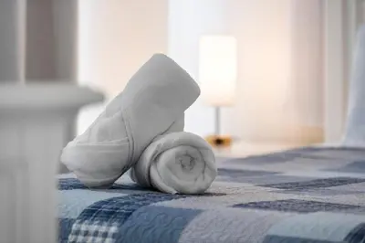 a rolled up towel is laying on a bed at Lakeview Family Haven in Kissimmee - Pool & Scenic Views in Kissimmee