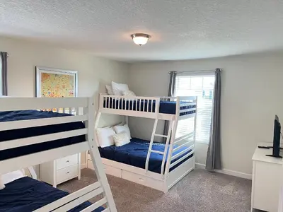 a bedroom with two bunk beds and a window at Wonderful home close to disney & universal in Kissimmee