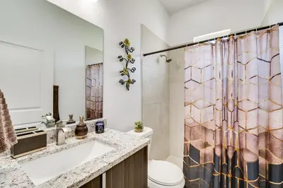 a bathroom with a sink and a shower curtain at 3 Mi to Lakefront Beach St Cloud Apt in Ashton