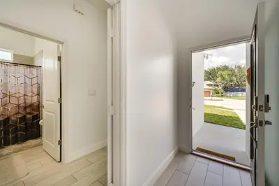 a hallway with a door leading to a yard at 3 Mi to Lakefront Beach St Cloud Apt in Ashton