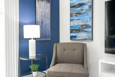 a living room with a chair and a lamp at Fantastic 4 Bd w Pool at Storey Lake Resort 2709 in Kissimmee