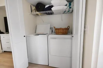a laundry room with two washes and a drying rack at Watch the Sunrise on Lake Louisa in Clermont