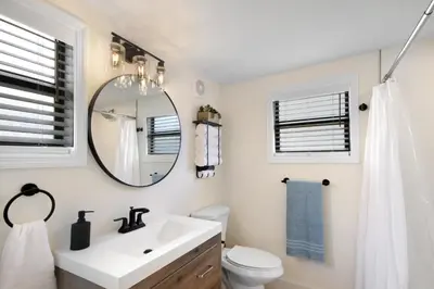 a bathroom with a sink and a mirror at Watch the Sunrise on Lake Louisa in Clermont