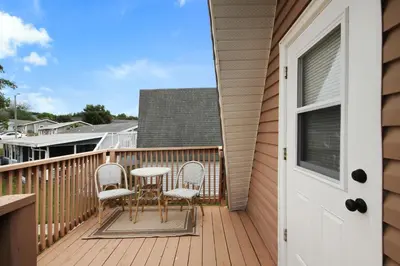 a balcony with a table and chairs on a house at Watch the Sunrise on Lake Louisa in Clermont