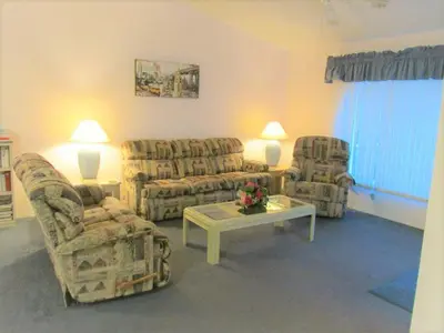 a living room with couches and a table and chairs at Christine's Villa in Kissimmee