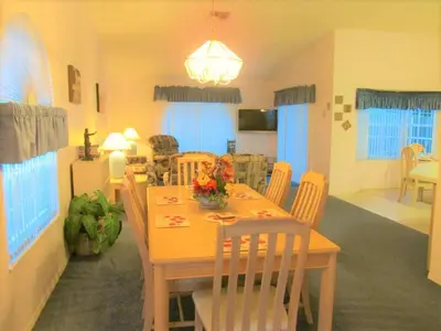 a dining room and living room with a table and chairs at Christine's Villa in Kissimmee