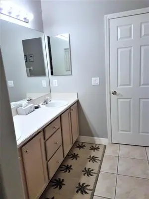 a bathroom with a sink and a mirror at Captain Jack's Getaway in Kissimmee