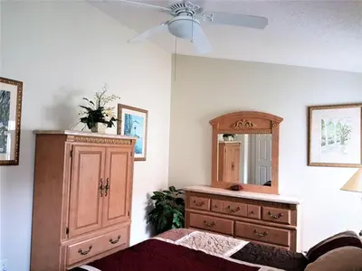 a bedroom with a dresser and a dresser with a mirror at Captain Jack's Getaway in Kissimmee