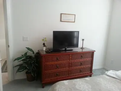 a tv on top of a dresser in a bedroom at Captain Jack's Getaway in Kissimmee