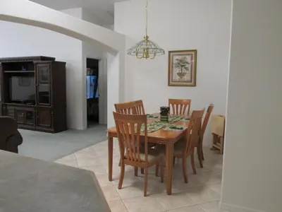 a dining room with a wooden table and chairs at Captain Jack's Getaway in Kissimmee