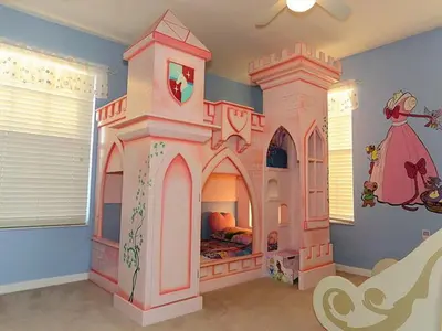 a childs bedroom with a large pink castle bed at Princess Hideaway in Orlando