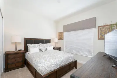 a bedroom with a large bed and a window at Stunning Storey Lake Villa Prime Location in Kissimmee