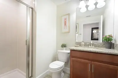 a bathroom with a toilet and a shower and a sink at Stunning Storey Lake Villa Prime Location in Kissimmee