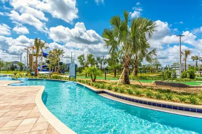 a pool at a resort with palm trees at Stunning Storey Lake Villa Prime Location in Kissimmee