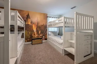 a bedroom with two bunk beds and a mural at Luxury Storey Lake Retreat - Spacious Disney-Near in Kissimmee