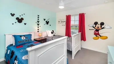 a room with a mickey mouse bedroom with a bed at Lake View 4 Bedroom Pool Home in Kissimmee