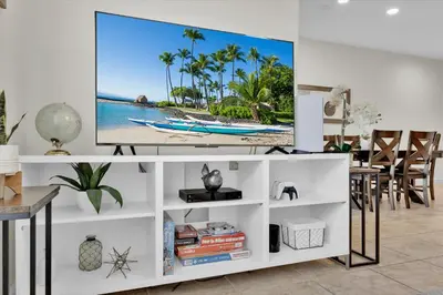 a living room with a tv on a white entertainment center at Lake View 4 Bedroom Pool Home in Kissimmee