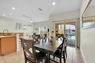 a kitchen and dining room with a table and chairs at Lake View 4 Bedroom Pool Home in Kissimmee