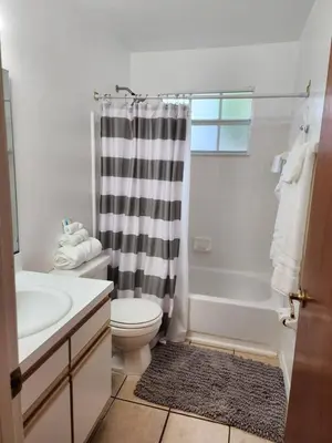 a bathroom with a sink and a toilet and a shower at Cozivill in Kissimmee