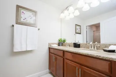 a bathroom with two sinks and a large mirror at Private Pool Prime Location Beautiful Home in Kissimmee