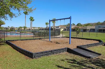 a park with a swing set in a playground at Luxury 4BR Home - Private Pool BBQ - Near Disney in Kissimmee