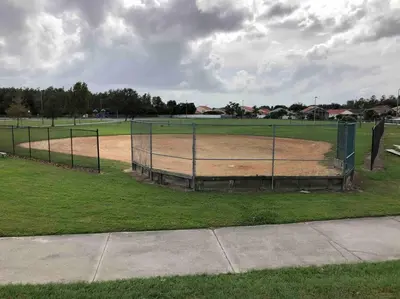 a baseball field with a fence in the middle at Luxury Waterfront 3b2b Heated Pool , Game Room , Piano House in Kissimmee