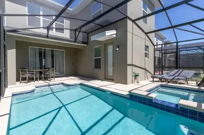 a swimming pool with a patio and a house at Chic & Spacious Best Vacation Home in Kissimmee