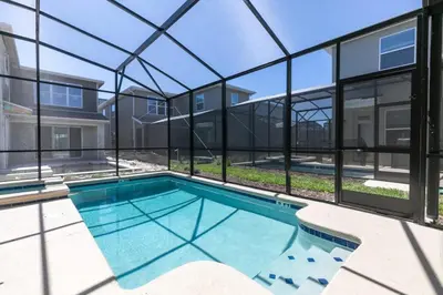 a swimming pool in a building with windows at Chic & Spacious Best Vacation Home in Kissimmee