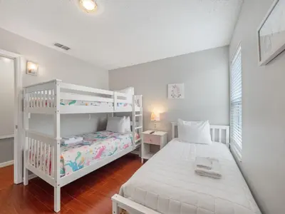 a bedroom with a bunk bed and a white bunk bed at bsv_villa2633 in Kissimmee