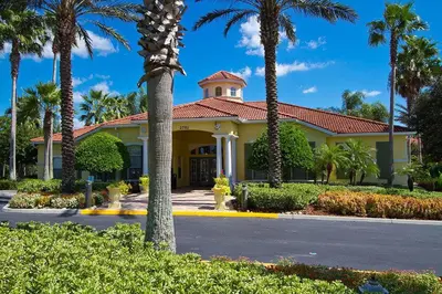 a yellow building with palm trees in front of it at bsv_villa2633 in Kissimmee