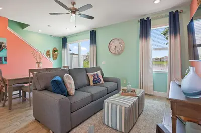 a living room with a couch and a table at Surfstyle at Margaritaville by Shine Villas 022 villa in Orlando
