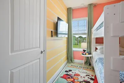 a childs bedroom with orange walls and a bunk bed at Surfstyle at Margaritaville by Shine Villas 022 villa in Orlando