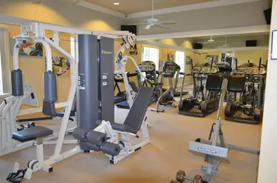 a gym with a lot of treadmills and ellipticals at 1320 - Aladin Cozy Bella Vida Kissimmee Close Disney in Kissimmee