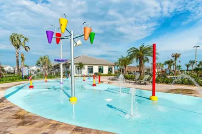 a pool with water fountains in a park at Charming 4BR with Private Heated Pool & BBQ Grill in Kissimmee