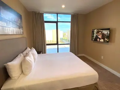 a bedroom with a large bed with a large window at Elegant Home w 3 En Suites & Breathtaking View in Orlando