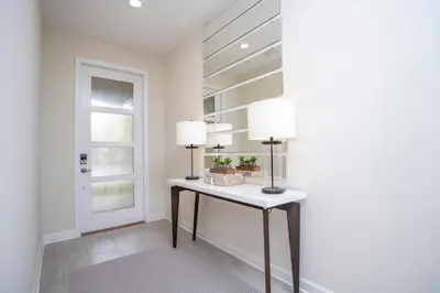 a room with a table with two lamps on it at Stunning 5BR Home - Your Dream Getaway in Kissimmee