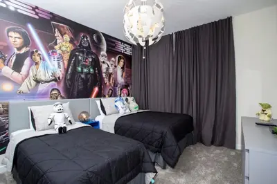 a bedroom with two beds and a large poster at Stunning 5BR Home - Your Dream Getaway in Kissimmee