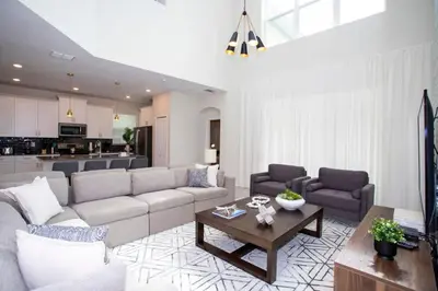 a living room with a couch and a table at Stunning 5BR Home - Your Dream Getaway in Kissimmee
